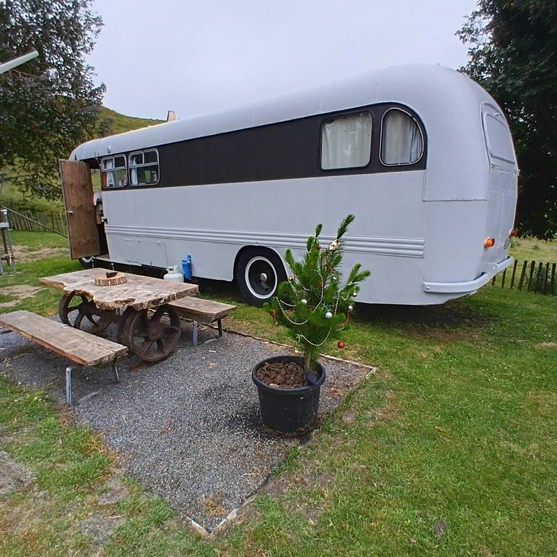 Vintage white caravan with picnic table