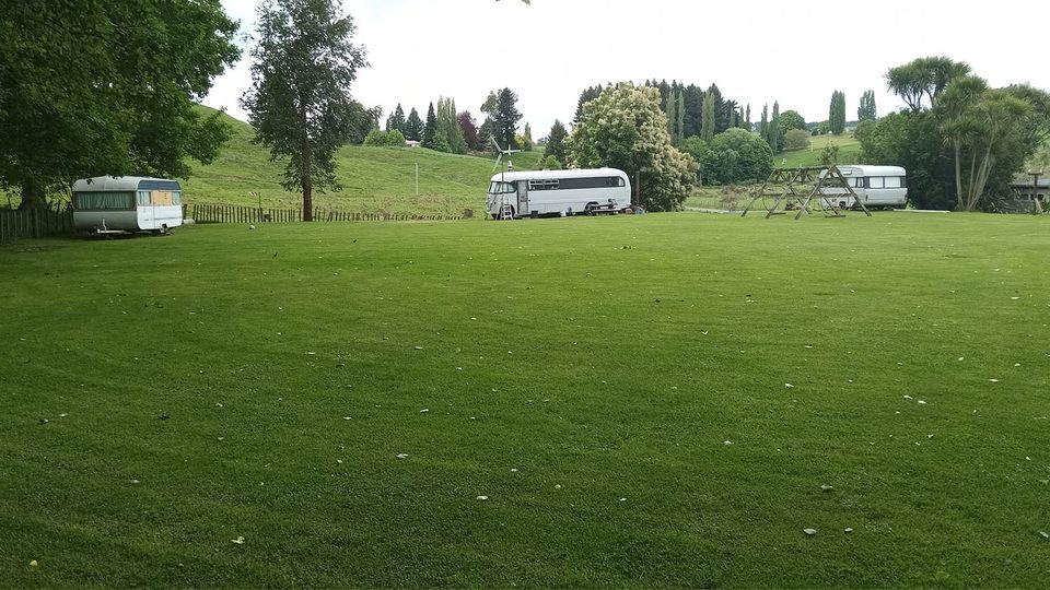 Sanctuary Farm campground with caravans and buses on the rugby field