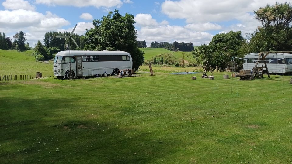 Sanctuary Farm grounds — caravans and buses parked on the open rugby field